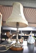A vintage silver-plated table lamp on wooden base having fringed lamp shade, measures 67cm overall.
