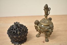 A vintage bronze inkwell sold together with a small metallic lotus incense burner.
