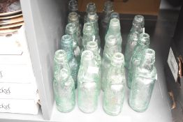 A selection of twenty antique glass Codd neck bottles including names W Mainwood Windsor and