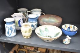 An assortment of studio pottery items to include jugs and bowls etc.