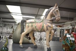 A large hand-carved wooden horse study, measures 46cm x 39cm, crack to hind leg.