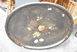 A large Victorian hand-painted Paper-Mache serving tray of oval form decorated with a floral bouquet