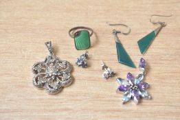 A silver marcasite set floral pendant, along with a silver blue and purple paste set pendant, a pair
