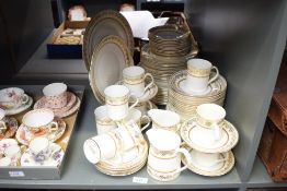 A 20th Century bone china part dinner service having gilt heightened design, stamped to base