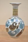 A vintage studio pottery vase having attractive blue and brown design, measures 22cm tall.