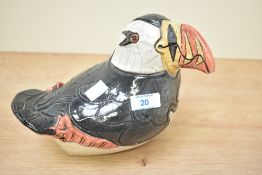 A Raku/crackle-Glazed ceramic puffin sculpture in the style of Jennie Hale, measures 19cm tall.
