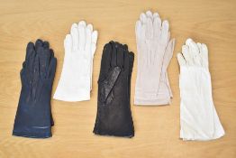 Five pairs of vintage ladies leather gloves, in navy, two cream, pale taupe, and black