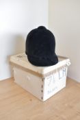 A 20th century Derby House Saddlery riding hat in black velvet, with local interest having been