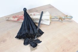 Two antique and vintage parasols, to include a Victorian / Edwardian mourning piece, with small
