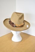 A vintage Nieman Marcus 'Red River' collection Western style hat, in tan with pheasant feather wrap,