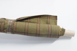 A bolt of Abraham Moon and Sons 100% pure wool tartan, in mossy olive green with brown and wine