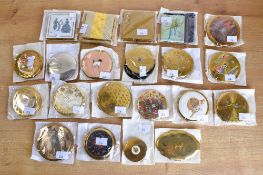 Twenty two vintage compacts with designs depicting animals, figures, historical or thematic