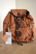 An Italian-made mini-rucksack in textured tan leather, with brown leather trimmings, straps,