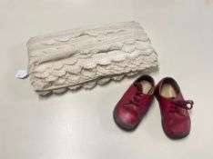 A pair of vintage child's shoes in red leather and a quantity of edging lace for upholstery or