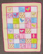 A 1990s-2000s quilt, 100% cotton, padded and stuffed, having a colourful printed patchwork design