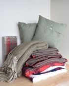 A quantity of soft home furnishings in sage green and red woollens, to include a pair of homemade,