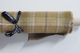 A bolt of Chess 100% wool tartan in Balmoral Beige, having a warm neutral base with subtle blue,