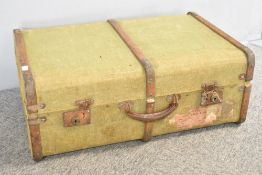 An early 20th century wood-framed suitcase, exterior lining in green canvas, measures 27 x 10 x 18