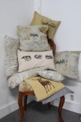 A collection of cushions and covers with a countryside theme, featuring farm animals, patterns