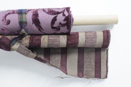 Three bolts of purple toned interiors fabrics, to include upholsterers jacquard in foliate flocked