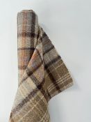 A bolt of Abraham Moon & Sons 100% pure wool tartan, in Autumn - Camel colour way, with shades of