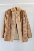 A vintage Saga Mink furs coat in soft taupe mink hide, having a raised fluffy feature collar and