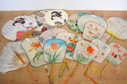 A collection of 20th century Chinese and Japanese handheld fans, hand painted, various materials