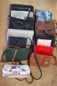Twelve mini cross-body bags, phone pouches, wallets and combination purses, in a range of colours