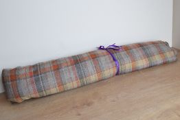 A bolt of curtain fabric in Courchavel Spice colourway, having neutral base with rust orange and