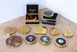 Eleven vintage compacts to include two Stratton in their boxes with velvette cloth bags, a large
