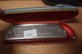 A vintage cased Hohner Chrometta 10 harmonica