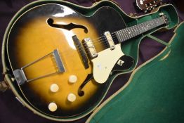 A vintage Harmony Rocket arch top electric guitar , with hard case, serial number stamped inside ,