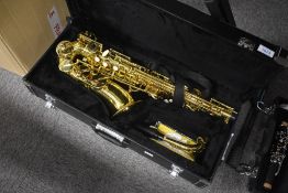 A modern cased saxophone , brand unknown