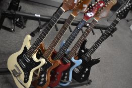 A selection of electric guitars , various designs, and a multi guitar stand