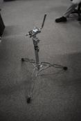 A DW tom stand, with clip for cymbal extension