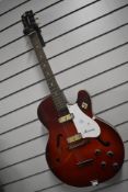 A Harmony H54 Rocket archtop electric guitar in red, stamped inside F-63, other numbers unclear