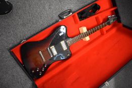 An electric guitar, sold as seen being possibly a composition/modification, in the Gibson Firebird