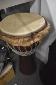 An African style djembe drum , height approx. 62cm