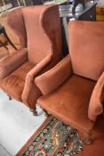 A 19th Century wingback armchair on mahogany turned legs with later russet dralon upholstery and a