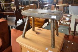 A traditional oak four legged milking or similar stool
