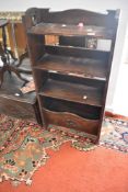 A late 19th or early 20th Century oak open bookshelf with magazine rack base, width approx. 56cm