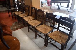 A set of six 19th Century rush seated chairs having rail and bobbin backs with turned stretcher