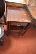 A late 19th or early 20th Century mahogany bedside or similar cabinet with drop flaps