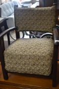 A vintage deep seated low armchair