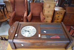 An early 20th Century oak cased wall clock having silvered dial with Arabic numerals