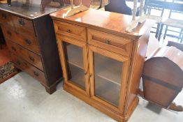 A modern mahogany effect glazed bookcase, width approx. 91cm, height 98cm