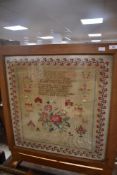 A golden oak fire screen/folding table having antique sampler insert , Elizabeth Parker (