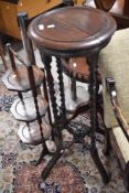 A circular twist oak plate stand and oak cake stand