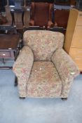 A vintage armchair having later elephant and bird upholstery