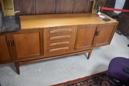 A vintage teak sideboard, G plan, having central bank of four drawers , flanked by double